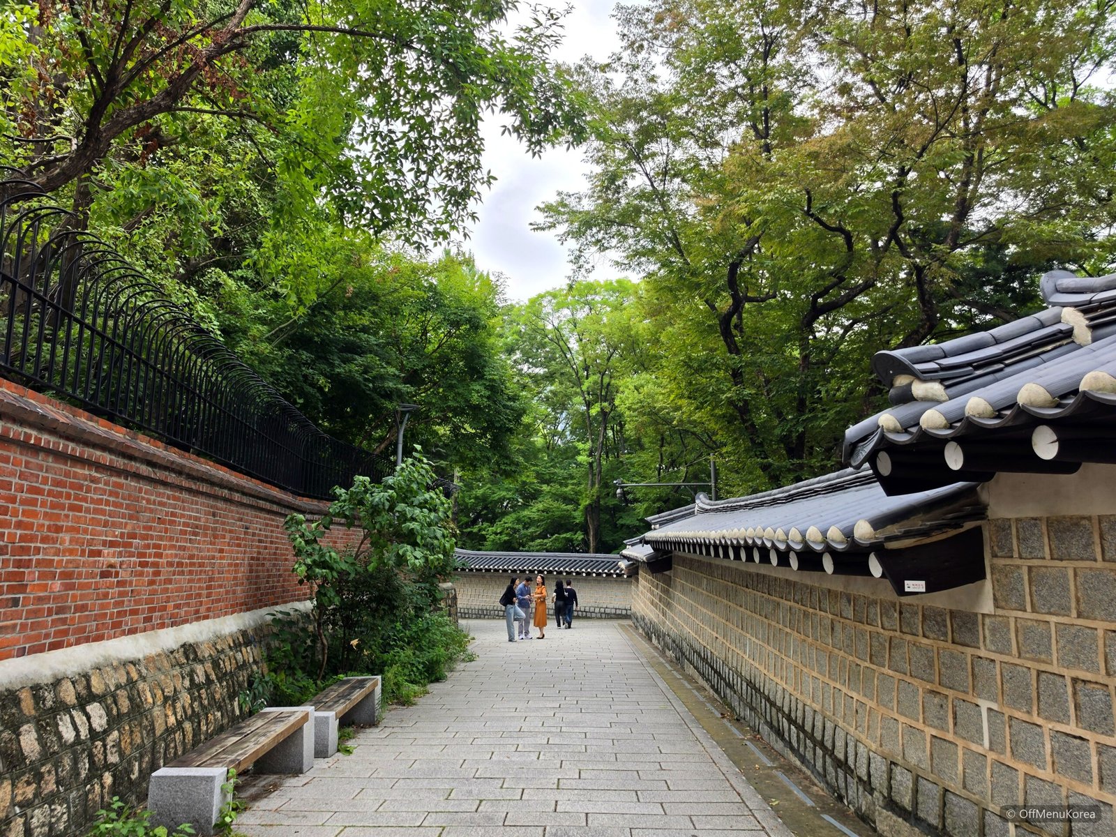 Quiet stone-wall footpath inside Deoksugung Palace